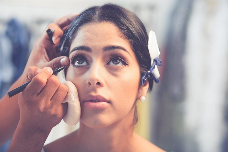 Girl looking up to let make-up artist