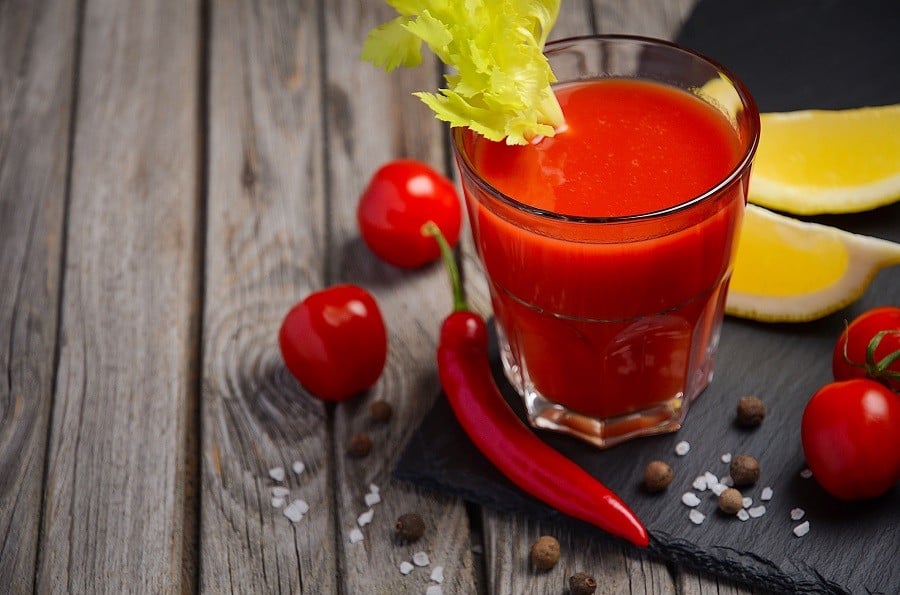 Bloody Mary cocktail on wooden background