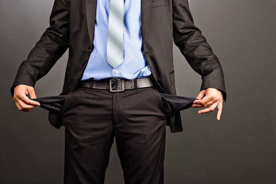 a broke man pulls out his pockets after a job rejection