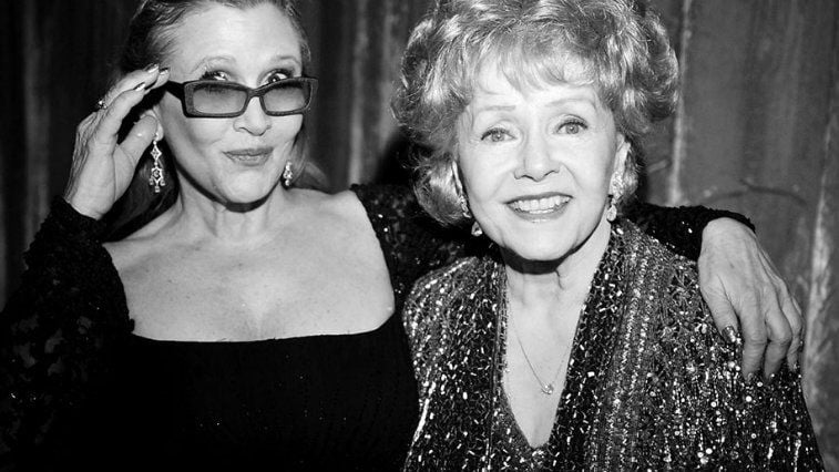 Carrie Fisher and mother Debbie Reynolds posing together in black and white