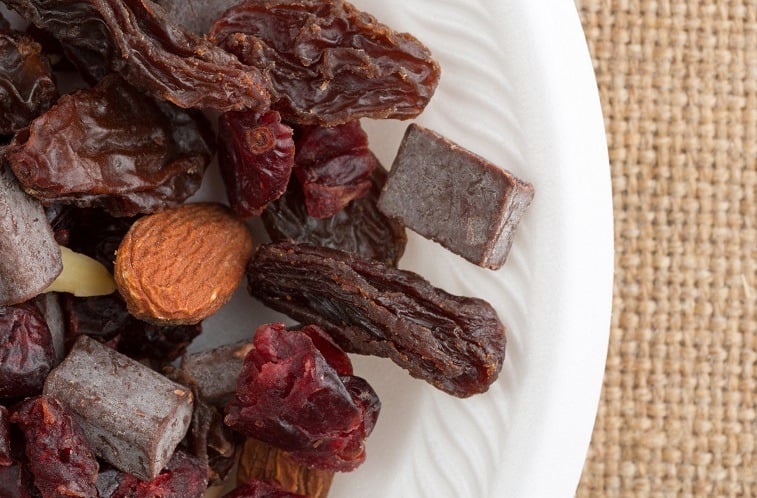 trail mix consisting of dried cranberries, sliced almonds, raisins and chunks of chocolate