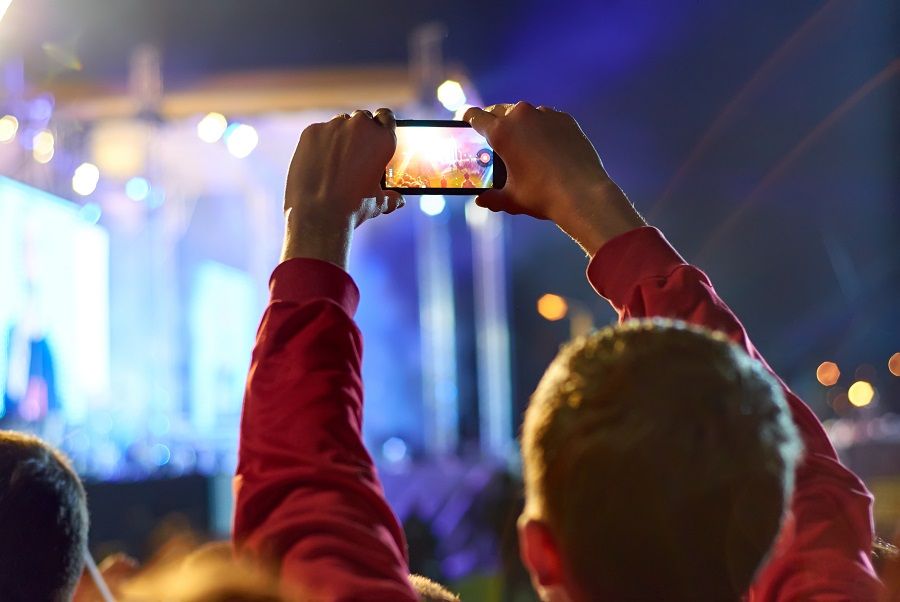 man recording video with smartphone