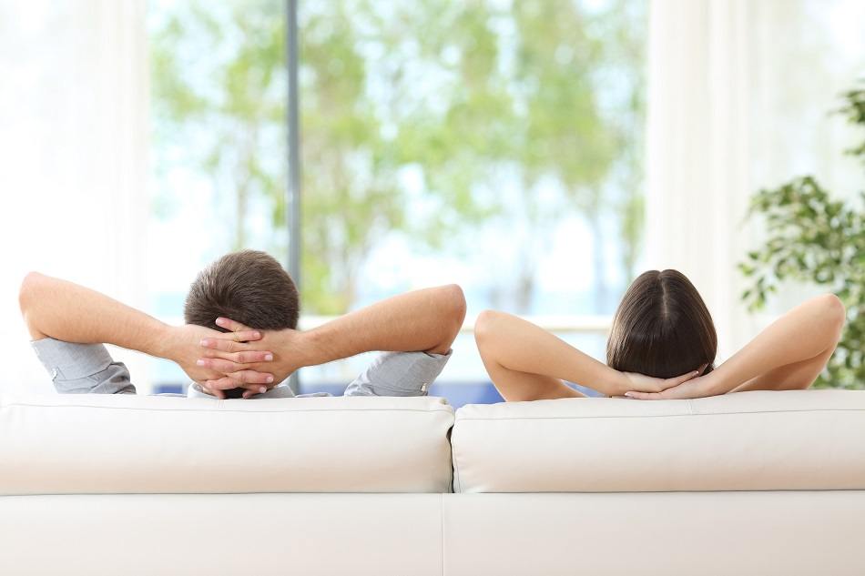 couple relaxing on a sofa at home