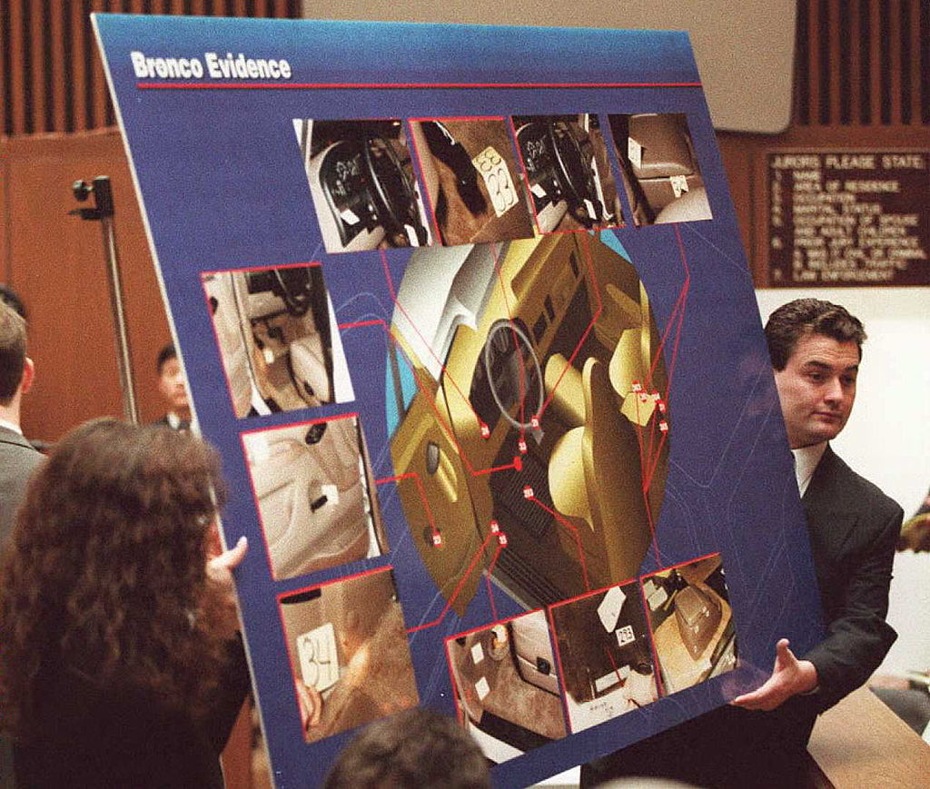 Court aides display a chart to the jury 04 April showing pictures and a diagram of where blood was found in O.J. Simpson's Ford Bronco during the O.J. Simpson murder trial in Los Angeles