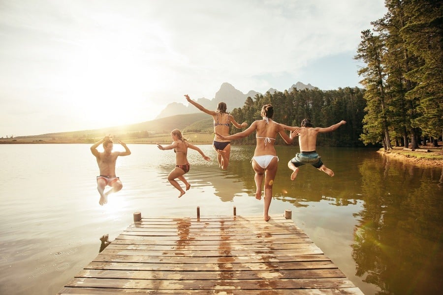 Young people having fun at the lake on a summer day