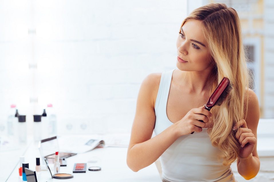 young woman looking at her reflection in mirror