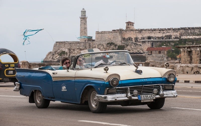 Tourists travel in a taxi, on January 8, 2014 in Havana. Taxi drivers in Cuba, who until now have been government employees, are to become self-employed workers, the latest in a raft of economic reforms on the Communist island. State-run media reported on Wednesday that the government was making the change with the goal of improving the island's slow and unreliable livery service. It also hopes to pare down the bloated government payroll on this island of some 11.1 million people.