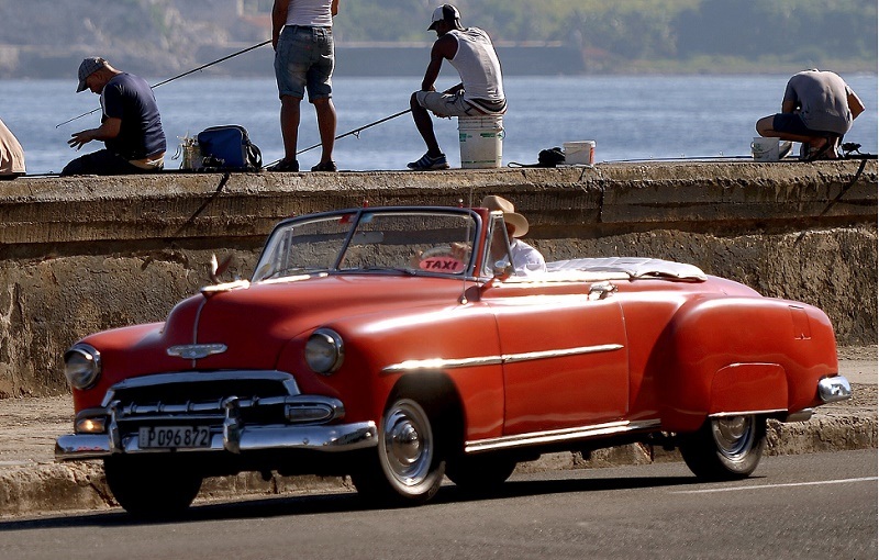 Men fish at Havana's Malecon a day before Pope Francis' arrival in Cuba on September 18, 2015.