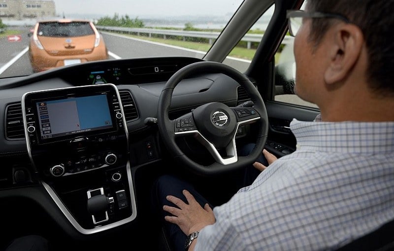 A journalist sitting in the driver's seat of the all-new minivan Serena from Japanese auto giant Nissan Motor takes his hands off the steering wheel during a test drive, at the test course of the company's Oppama plant in Yokohsuka, in suburban Tokyo, on July 13, 2016. Nissan will release the new vehicle, equipped with autonomous drive technology designed for highway use in single-lane traffic, in late August.