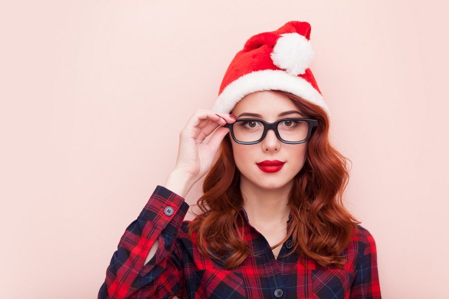 A girl wearing a Santa Claus hat