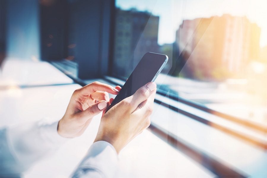 Girl touching a screen of her smartphone