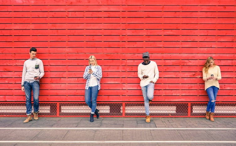 Group of multiracial fashion friends using smartphone