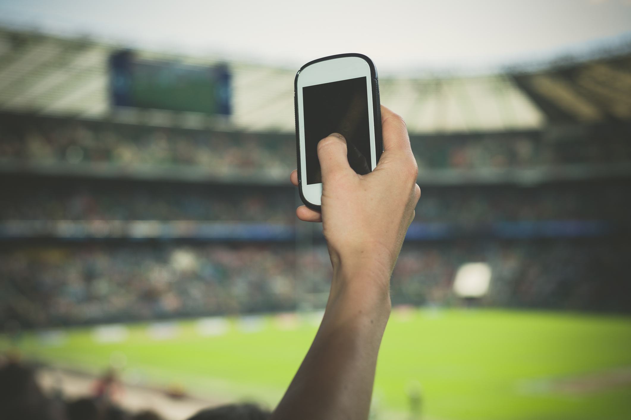 A female hand is holding a smartphone
