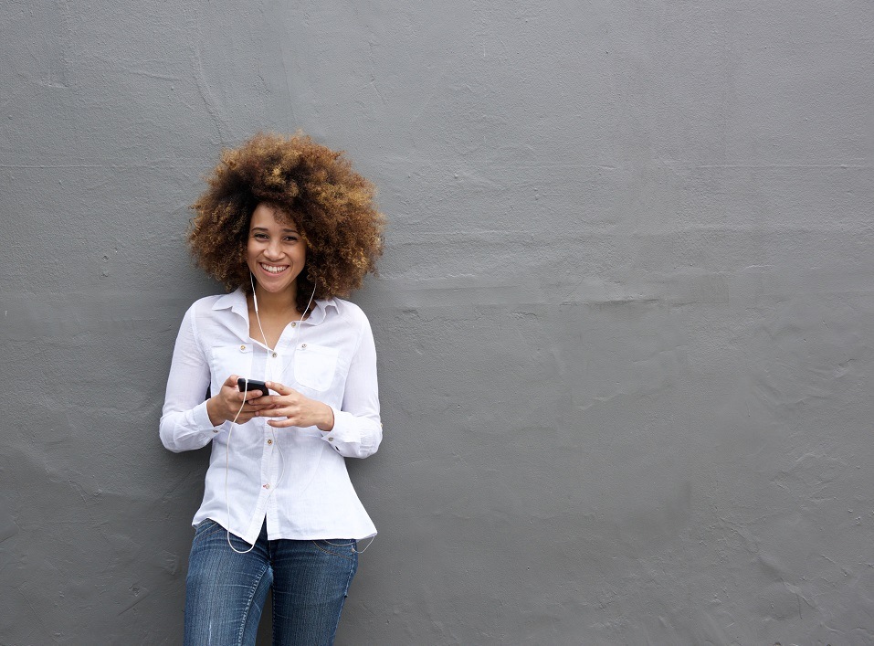young african american woman with afro listening to music