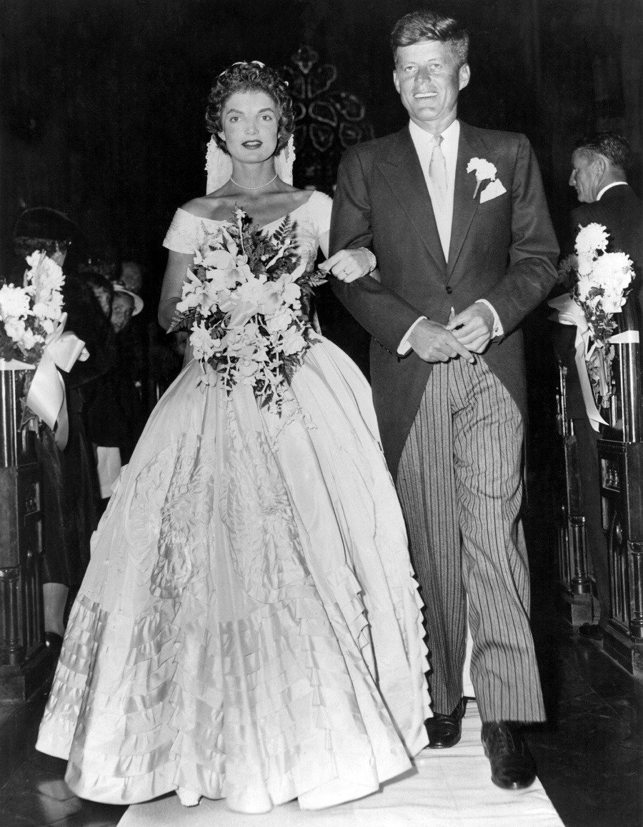 Senator John Fitzgerald Kennedy escorts his bride Jacqueline Lee Bouvier