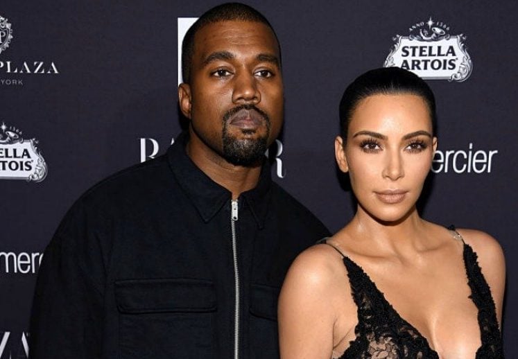 Kanye West and Kim Kardashian standing
