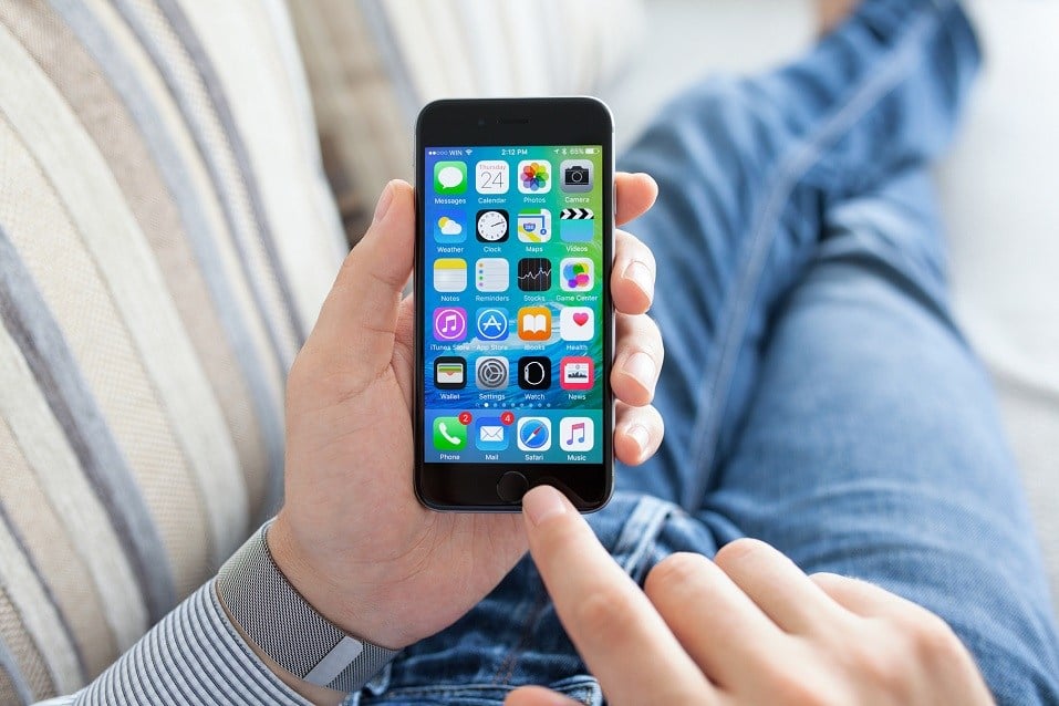 Man hand with Apple Watch holding iPhone