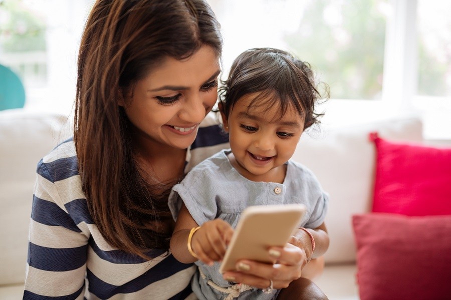 mother and baby playing with smartphone