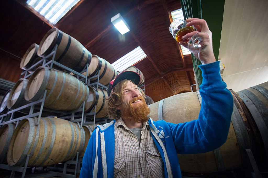 A man inspects his beer A man inspects his beer