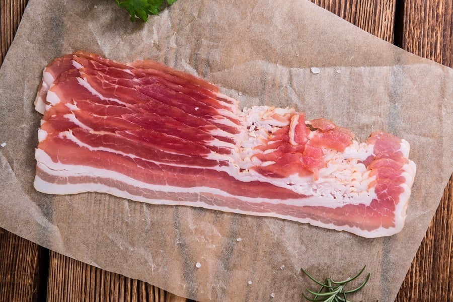 raw Bacon stripes on wooden background