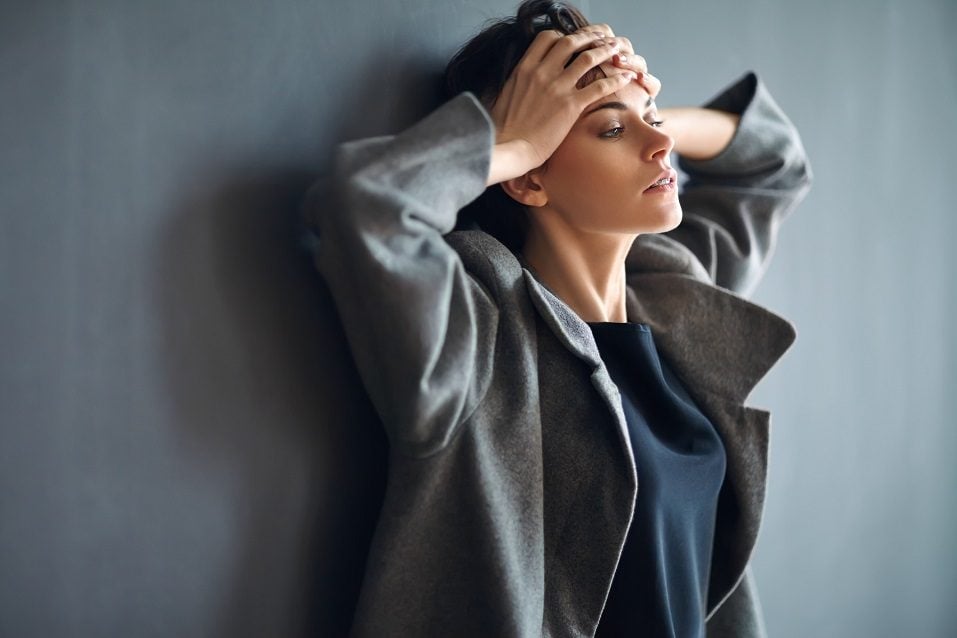 tired beautiful woman on dark background