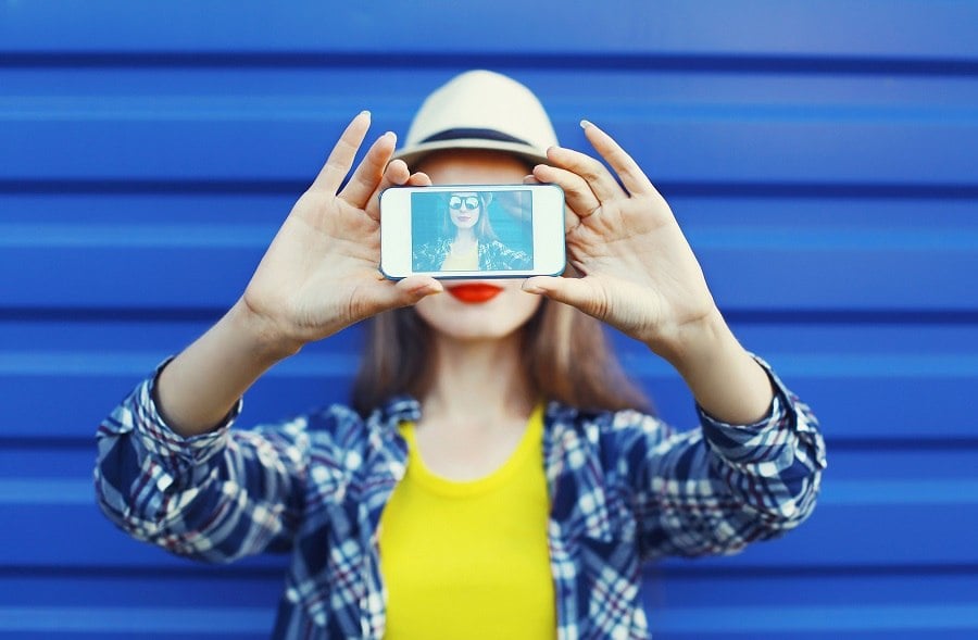 Girl taking a selfie with a smartphone