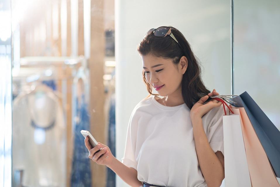 smiling pretty woman reading a message on her phone