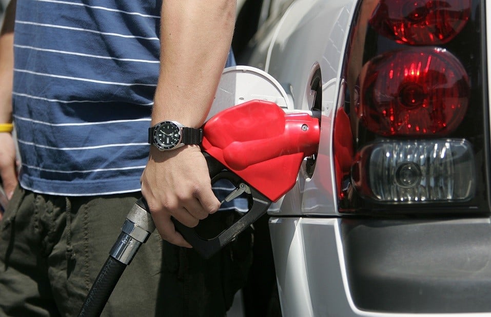 A man pumps gasoline into his car.