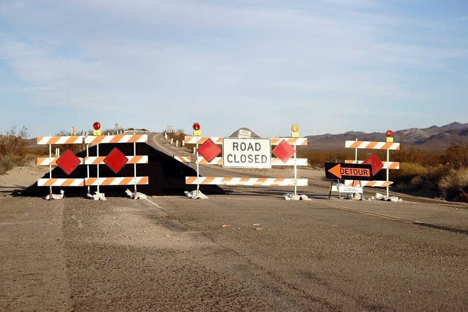 A road barrier with warning lights