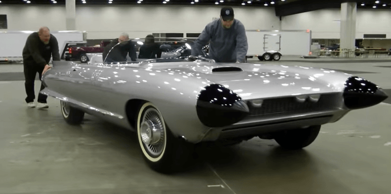 People pushing a 1959 Cadillac Cyclone