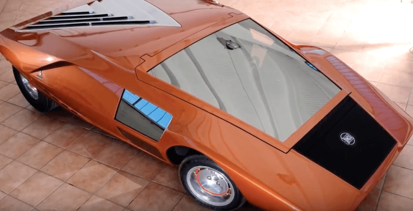 Orange 1970 Lancis Stratos HF Zero parked on tile