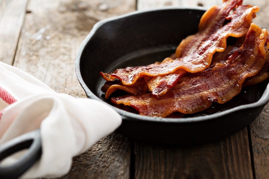 bacon pieces in a cast iron skillet