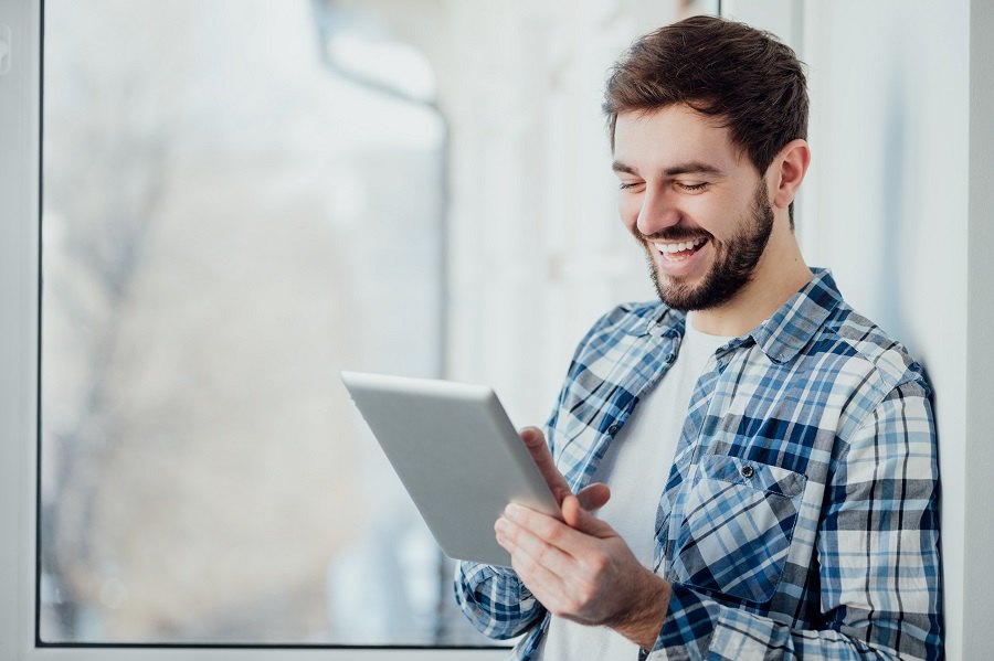smiling man shopping with tablet pc