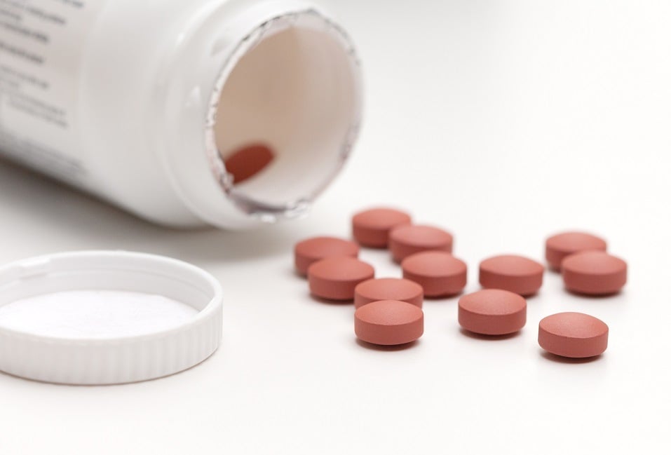 bottle of ibuprofen pills on a white background