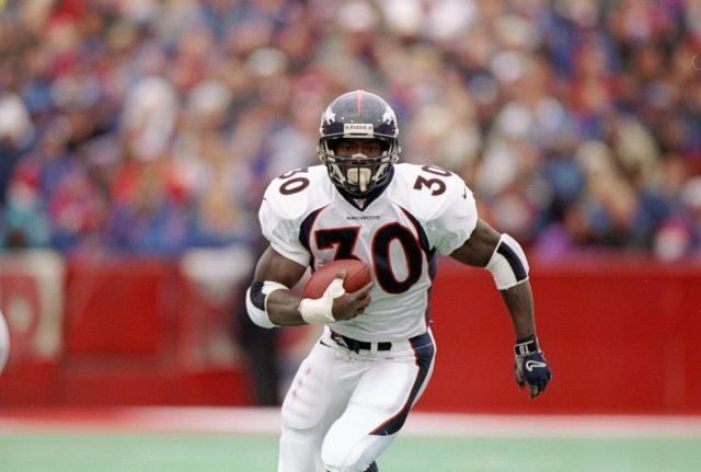 Terrell Davis running down the field with a football in hand. Terrell Davis running down the field with a football in hand.