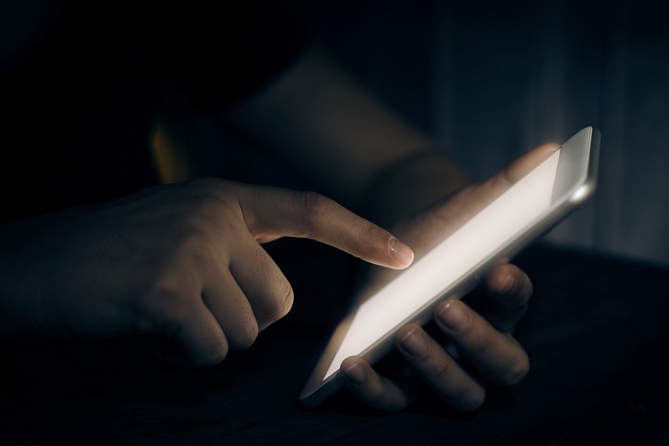 Hand touching a digital tablet