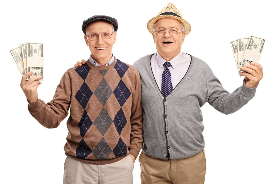 Two senior gentlemen holding several stacks of money