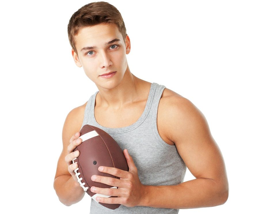 young man holding rugby ball