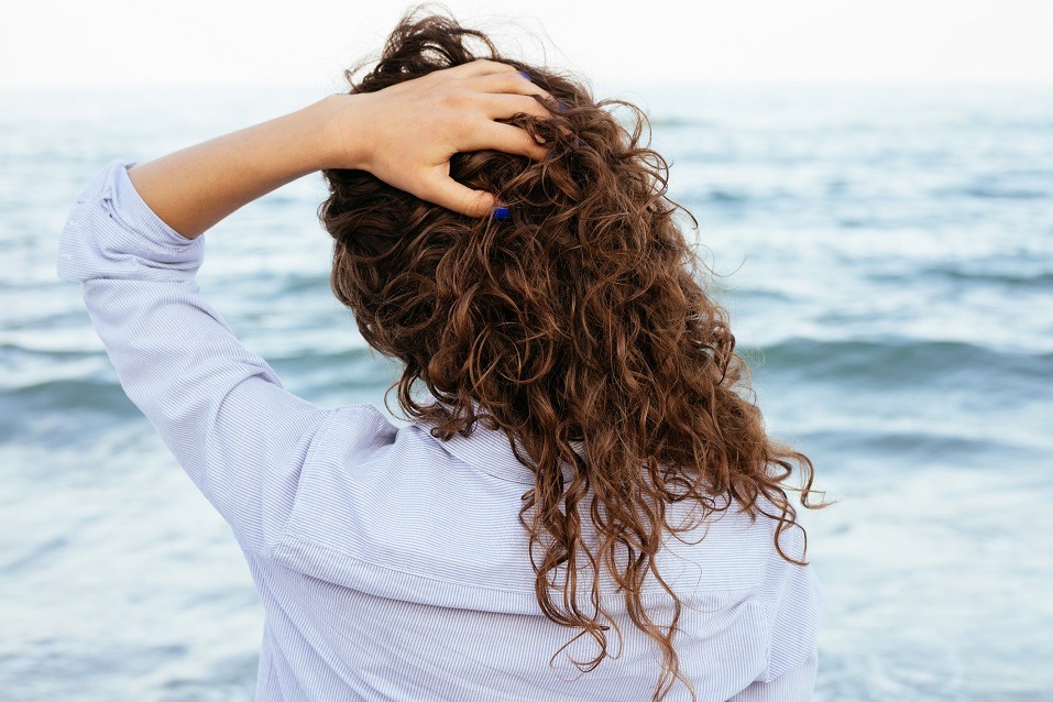 woman in shirt looking at the sea