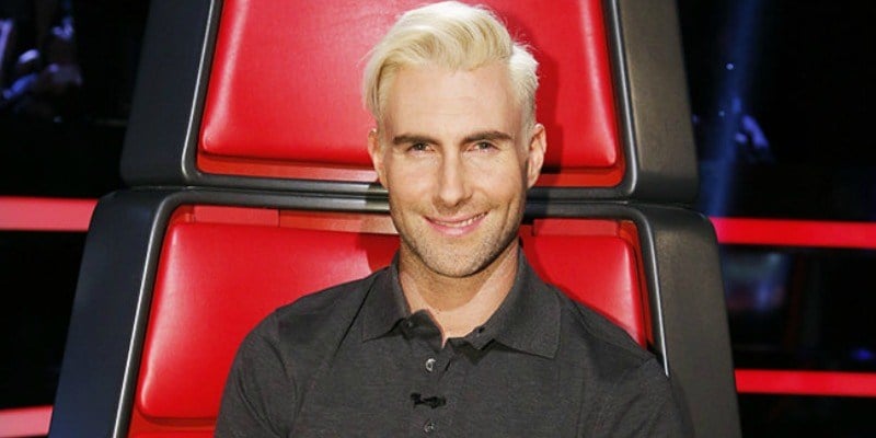 Adam Levine sitting in the chair on The Voice