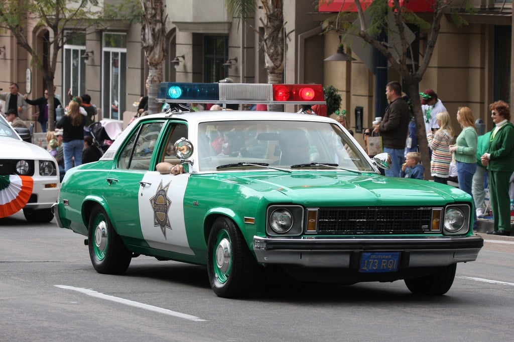 Green and white Chevrolet Nova cop car