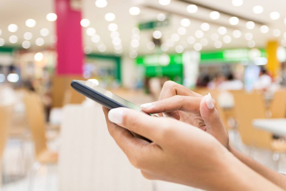 Woman's hand typing on a smartphone