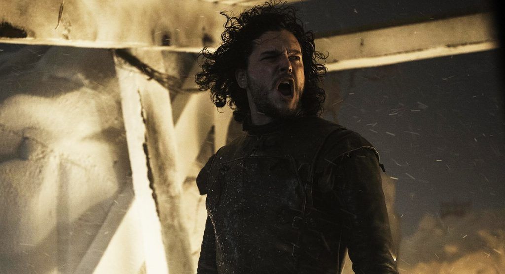 Jon Snow stands on the wall and calls out a command during a battle scene in 'Game of Thrones.'