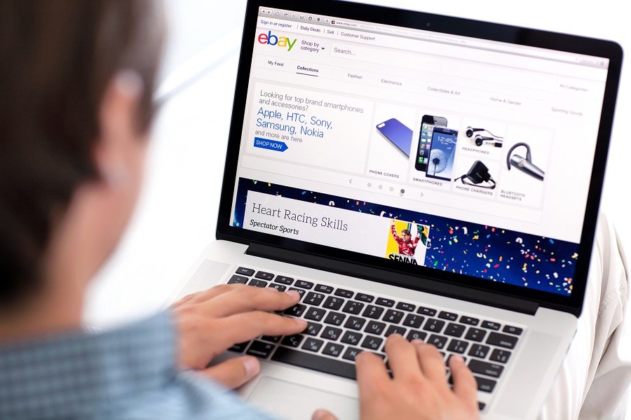 man accessing eBay on laptop