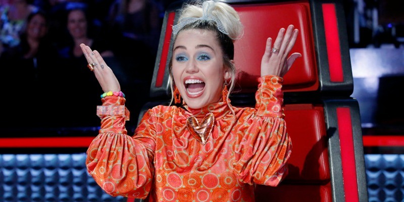 Miley Cyrus looking shocked on The Voice.