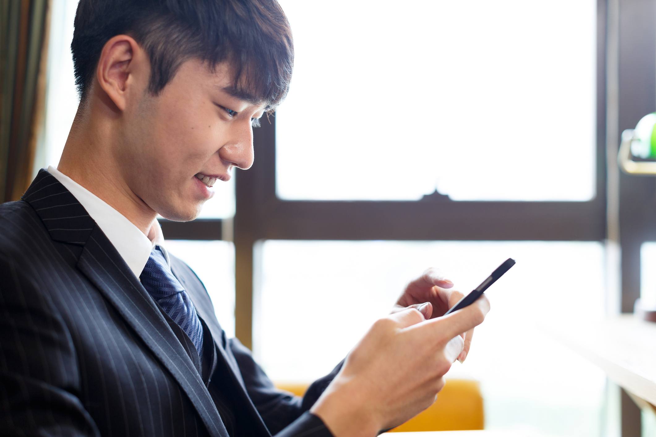 handsome man playing with cellphone