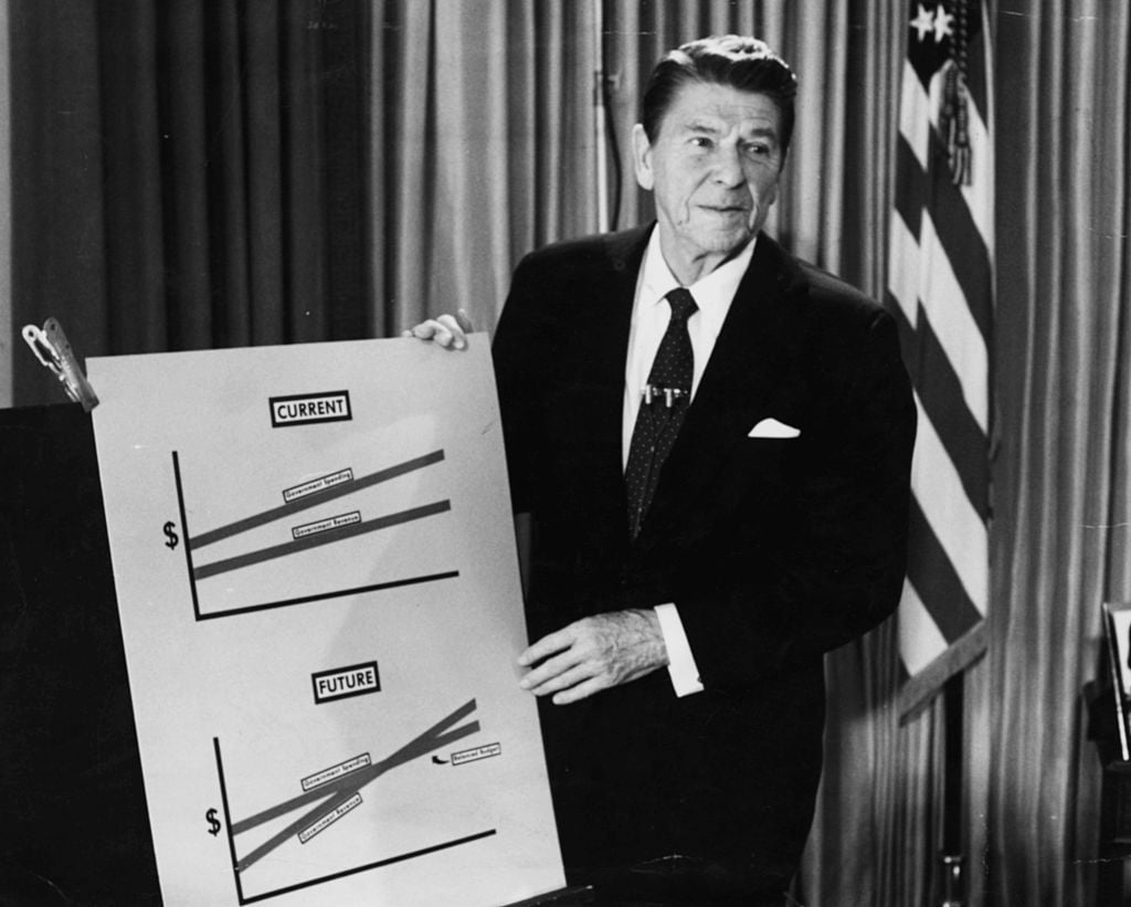 President Ronald Reagan holding a chart