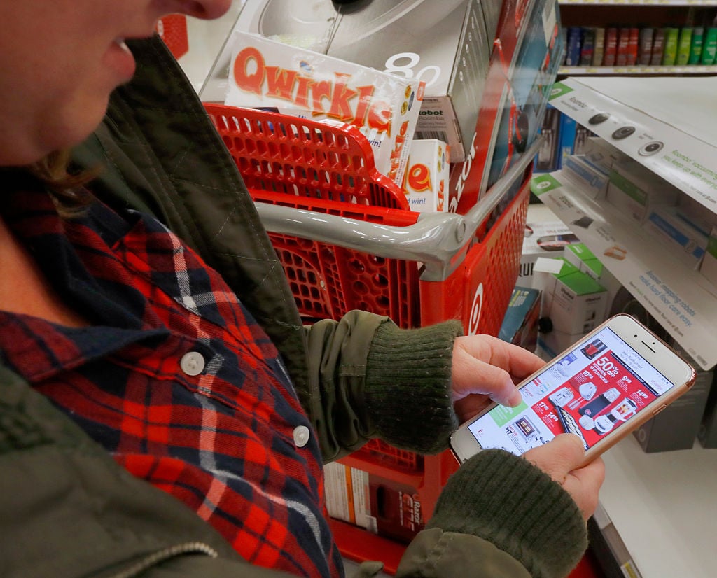 A shopper checks out an advertisement on her smartphone