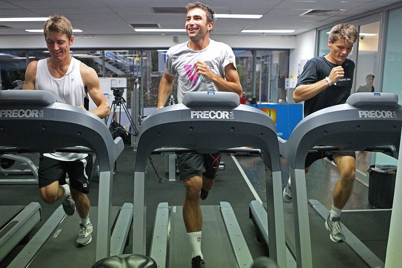 Three men hit the treadmill at the gym
