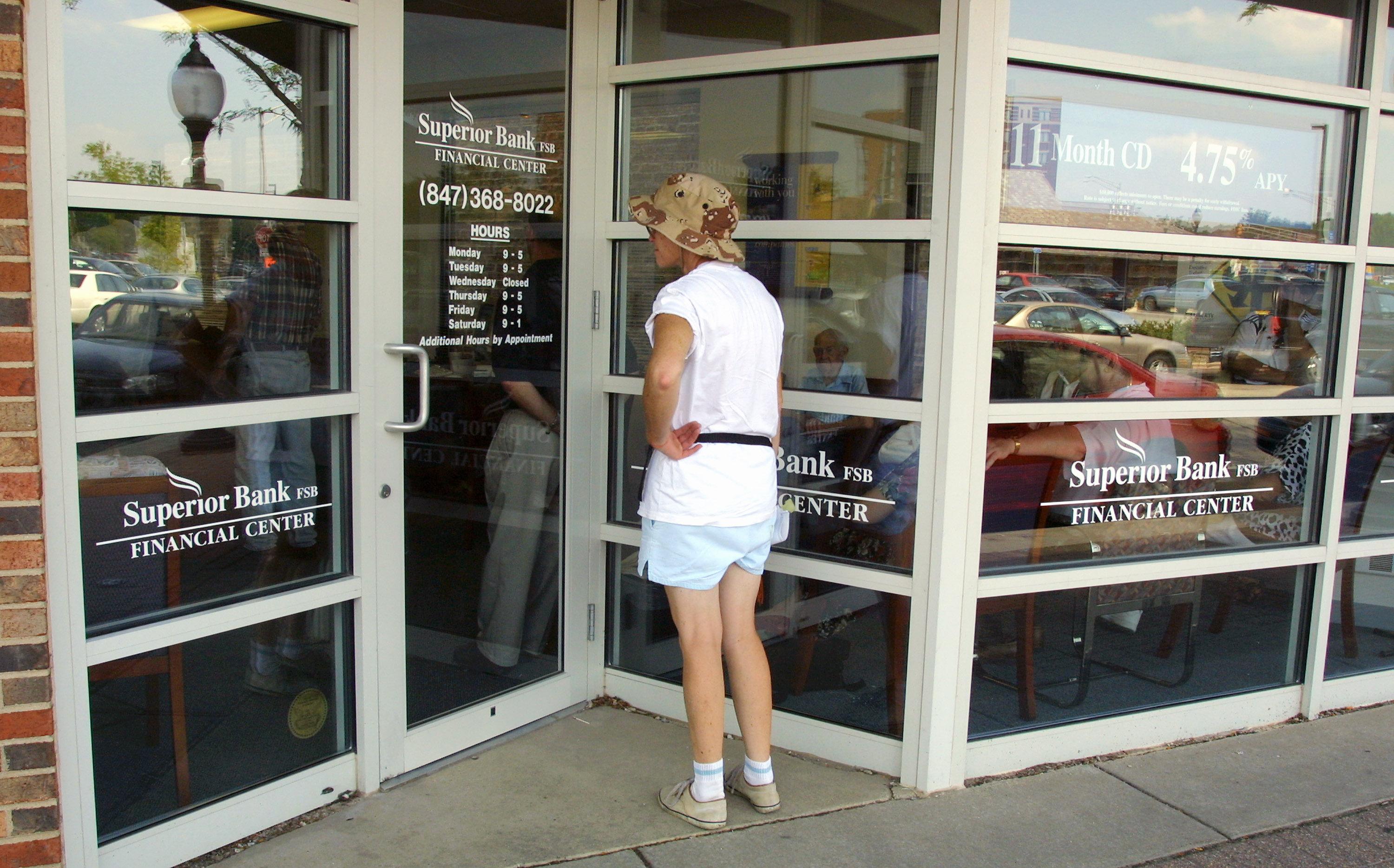 A bank customer stops at the door